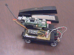 Photo of a mitEbot compared with a stapler